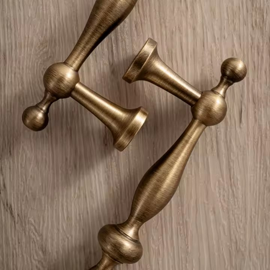Angle view of vintage bronze cabinet pull showing bow-shaped profile and hand-aged antique bronze patina finish