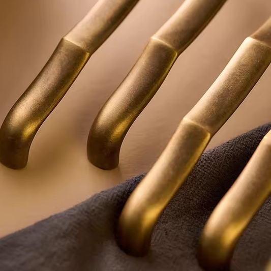 SOMERSET antique brass cabinet pull angled view showing cylindrical bar and backplate patina detail
