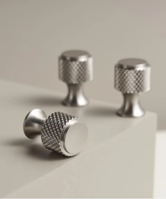 ARABELLA knurled knob angled view showing diamond-cut texture and brass construction