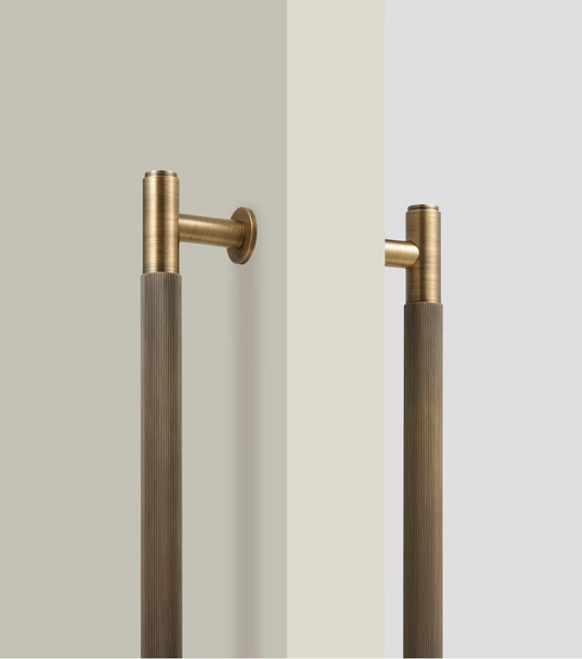 Solid brass linear striped pull bar angled view showing parallel stripe detailing and brushed finish