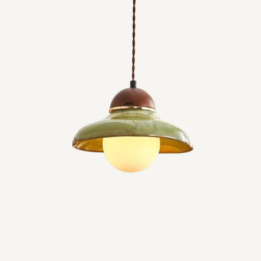 Green ceramic pendant light photographed at an angle revealing the textured exterior and interior glow
