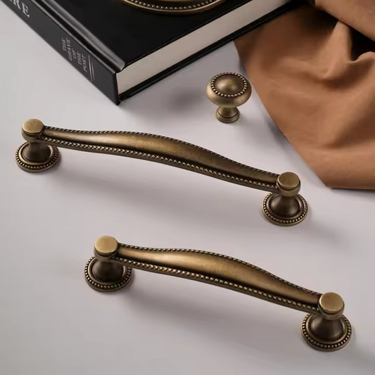 LANCASTER solid brass cabinet knob in antique bronze shell design, angled view showing relief cast detail