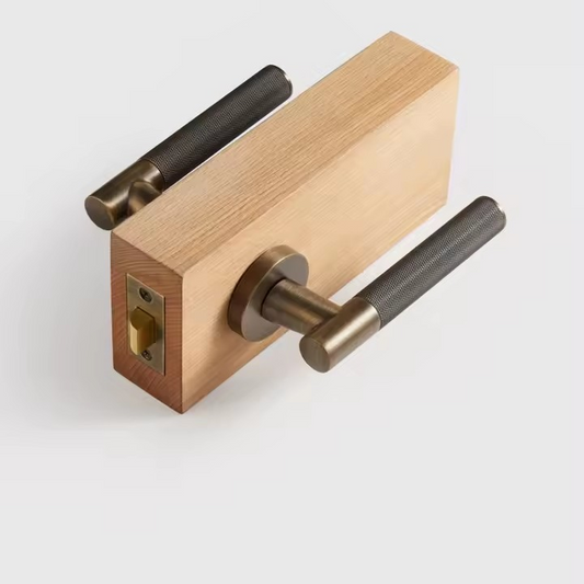 OPHELIA solid brass knurled cross door handle set photographed at an angle showing the cross-lever detail