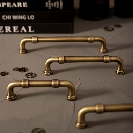 Antique bronze pull bar side angle showing the cylindrical bar profile and patina