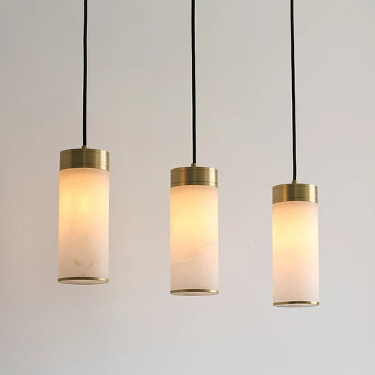 Emilio tri-pendant angled shot showing the three marble shades aligned at the same drop height