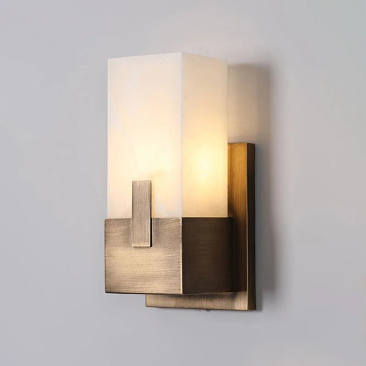 Angled view of HUDSON marble wall lamp highlighting natural stone veining and brushed brass wall fitting