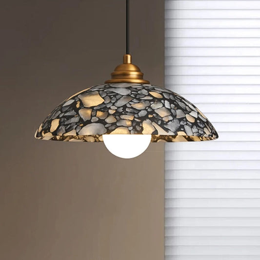 ADRIENNE marble pendant angled view showing natural veining and brass canopy