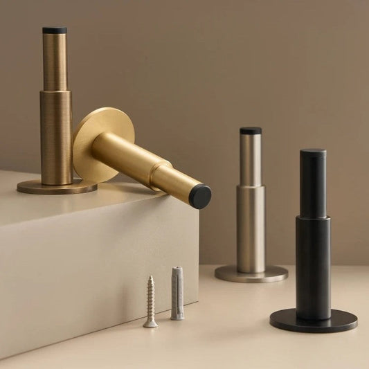 Solid brass door stop close-up showing smooth plain profile and 3dB sound-dampening core