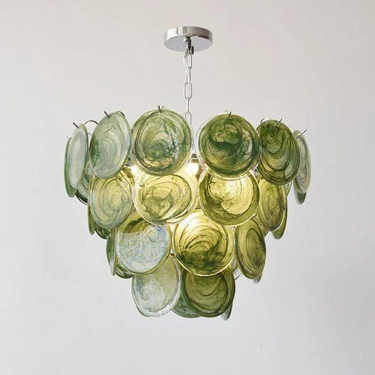 Angled view of ISABELLE chandelier highlighting the emerald green Murano glass pendants and antique brass fittings