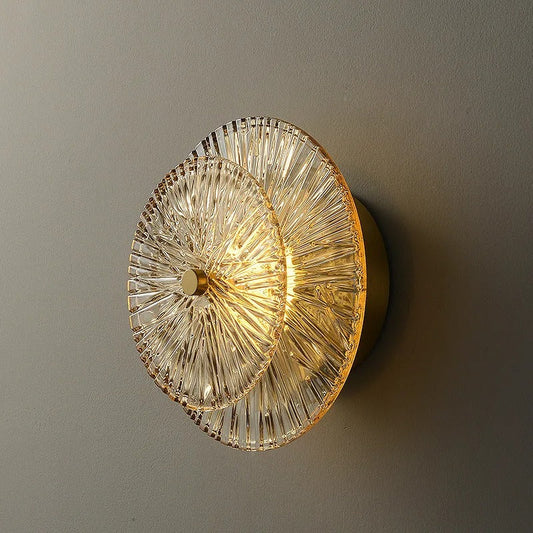 Glass wall lamp angle view showing the hand-blown shade and metal bracket detail