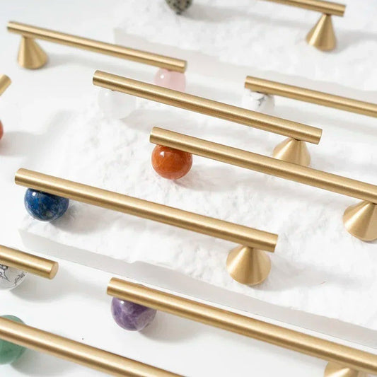 Brass cabinet handle side-angle view showing crystal inset and knurled grip