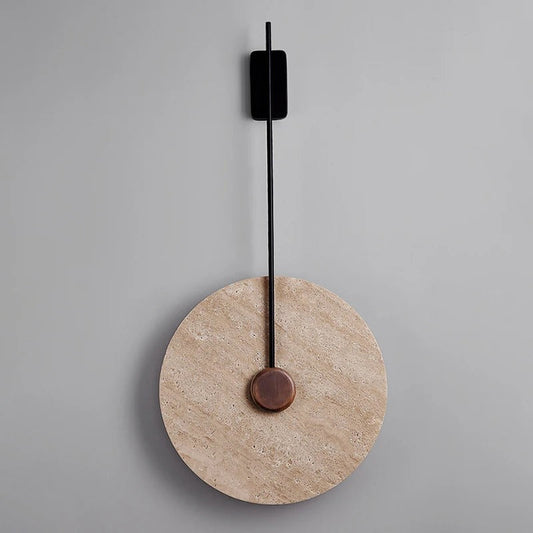 Celine travertine wall lamp at angle showing stone shade cut and brass arm