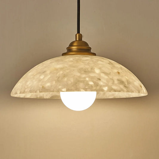 ADRIENNE white marble pendant angled view showing stone texture and brass canopy