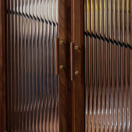 Angle view of TAY walnut wood pull handle showing warm grain detail and brass ferrule ends