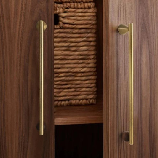 Walnut wood and brass pull bar shown at a three-quarter angle, emphasising natural grain