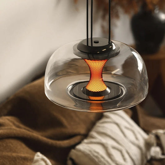 Maurice glass pendant light angled view showing hand-blown globe form and warm filament glow