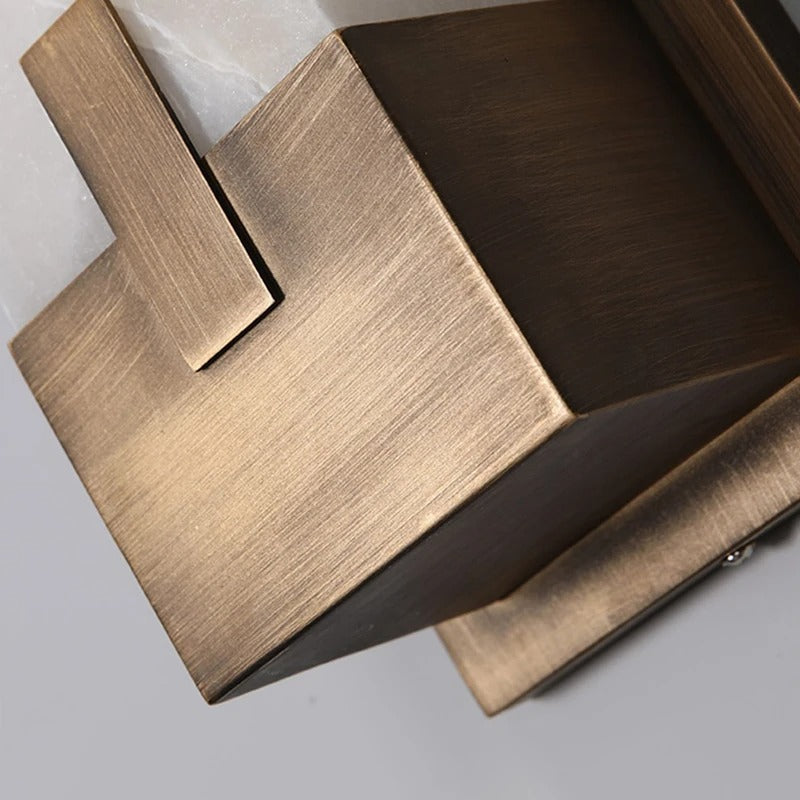 Detail of HUDSON wall lamp marble shade showing unique stone grain pattern and brass collar fixture