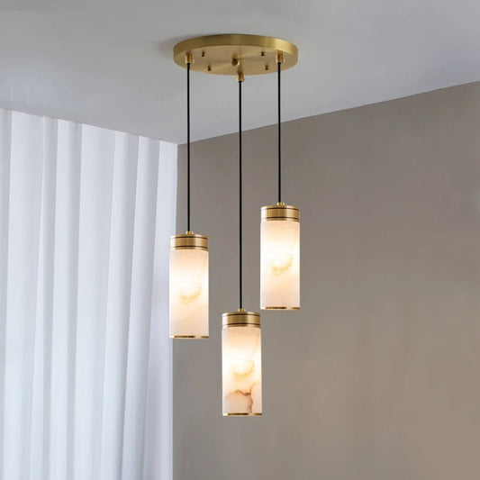 Emilio tri-pendant angled view showing the three Spanish marble shades at varied drop heights