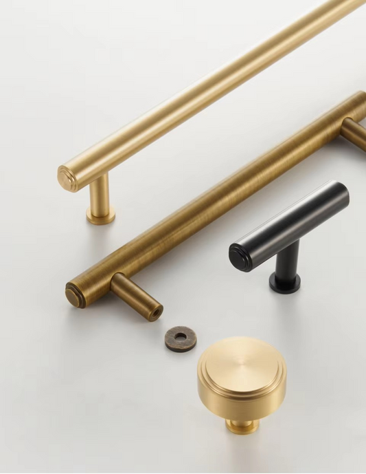 Solid brass T-bar cabinet knob angled view showing cylindrical bar and rounded base, polished finish detail