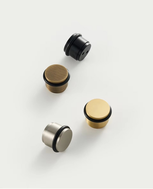 Angle view of brass door stopper showing heavy-duty construction and polished brass finish for lasting durability