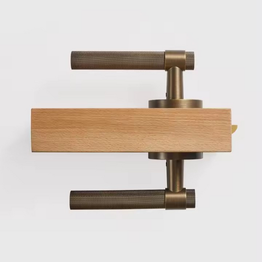ODETTE solid brass knurled door handle set photographed from a 45-degree angle to highlight the lever profile