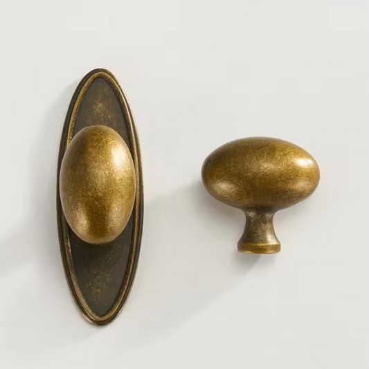 Angled view of JULIETTE solid brass egg door knob revealing elegant rounded profile and mounting rose