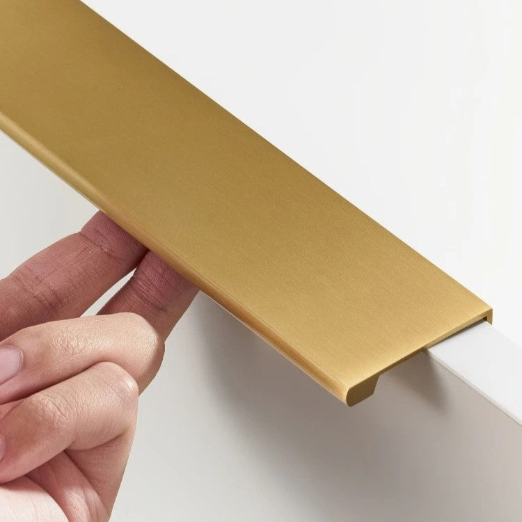 ERIN lip pull handle hero view on white, a sleek solid brass recessed pull with polished lip edge