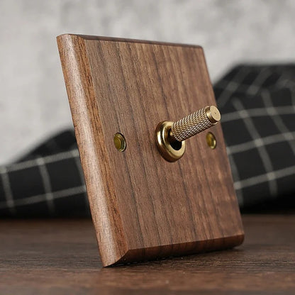 HALSTON walnut toggle switch installed on living room wall in Japandi-style interior