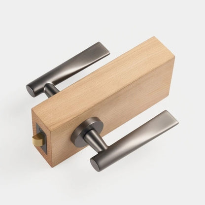 Gunmetal lever handle styled on bedroom door in modern interior setting