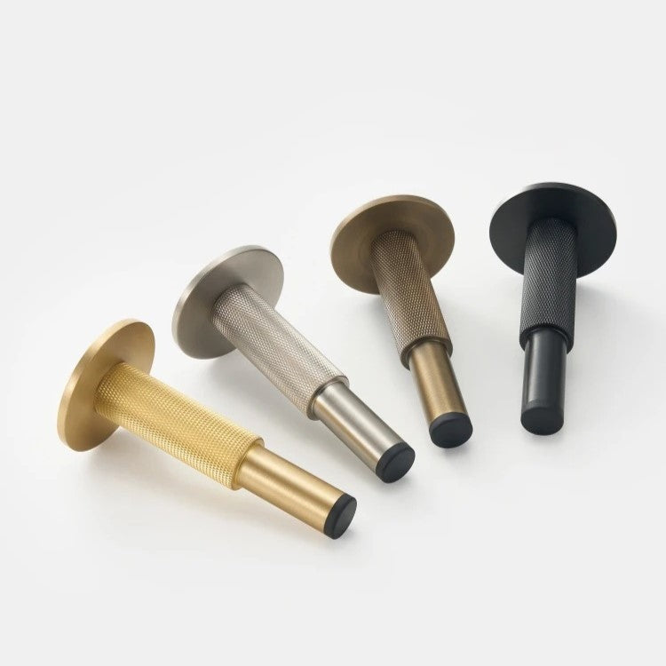 Detail of diamond knurled antique brass surface on ODETTE solid brass door stopper