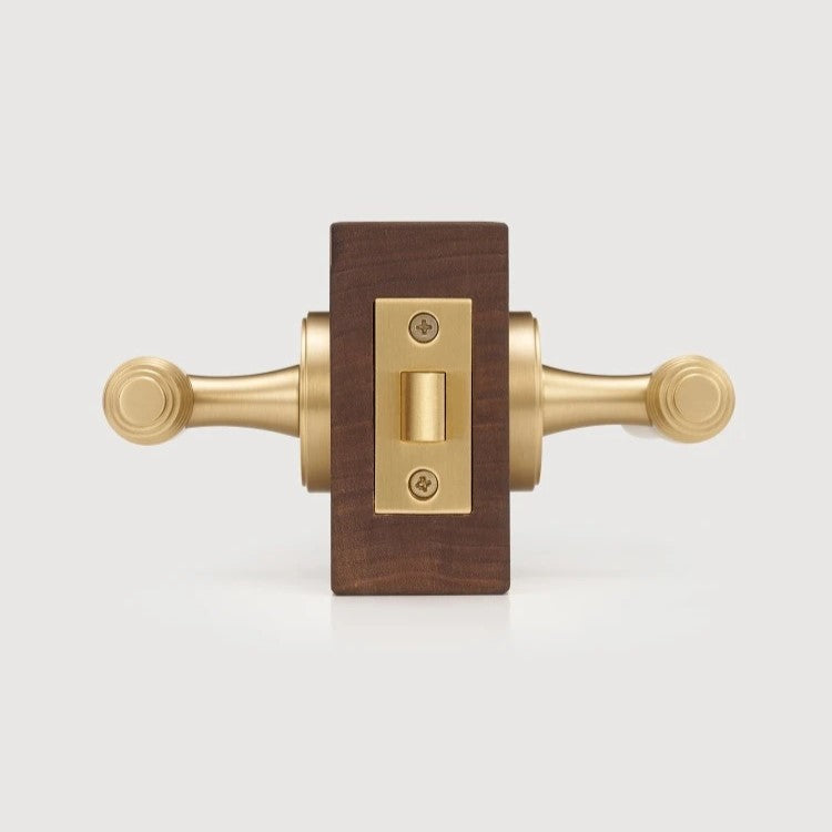 LUCCA lever handle styled in transitional interior with warm antique brass hardware