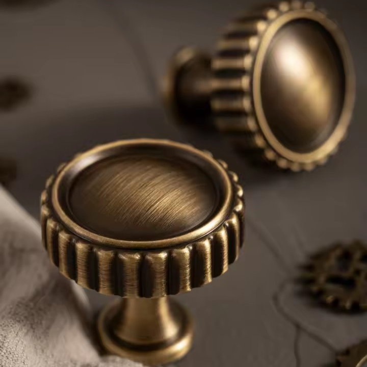 Antique bronze cup pull side view showing the arched profile and aged patina
